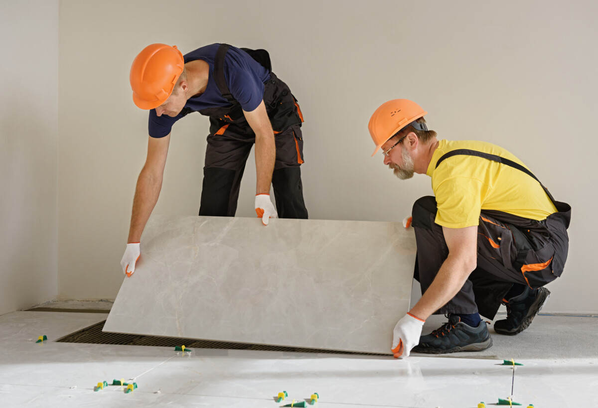 Installing a large ceramic tile.